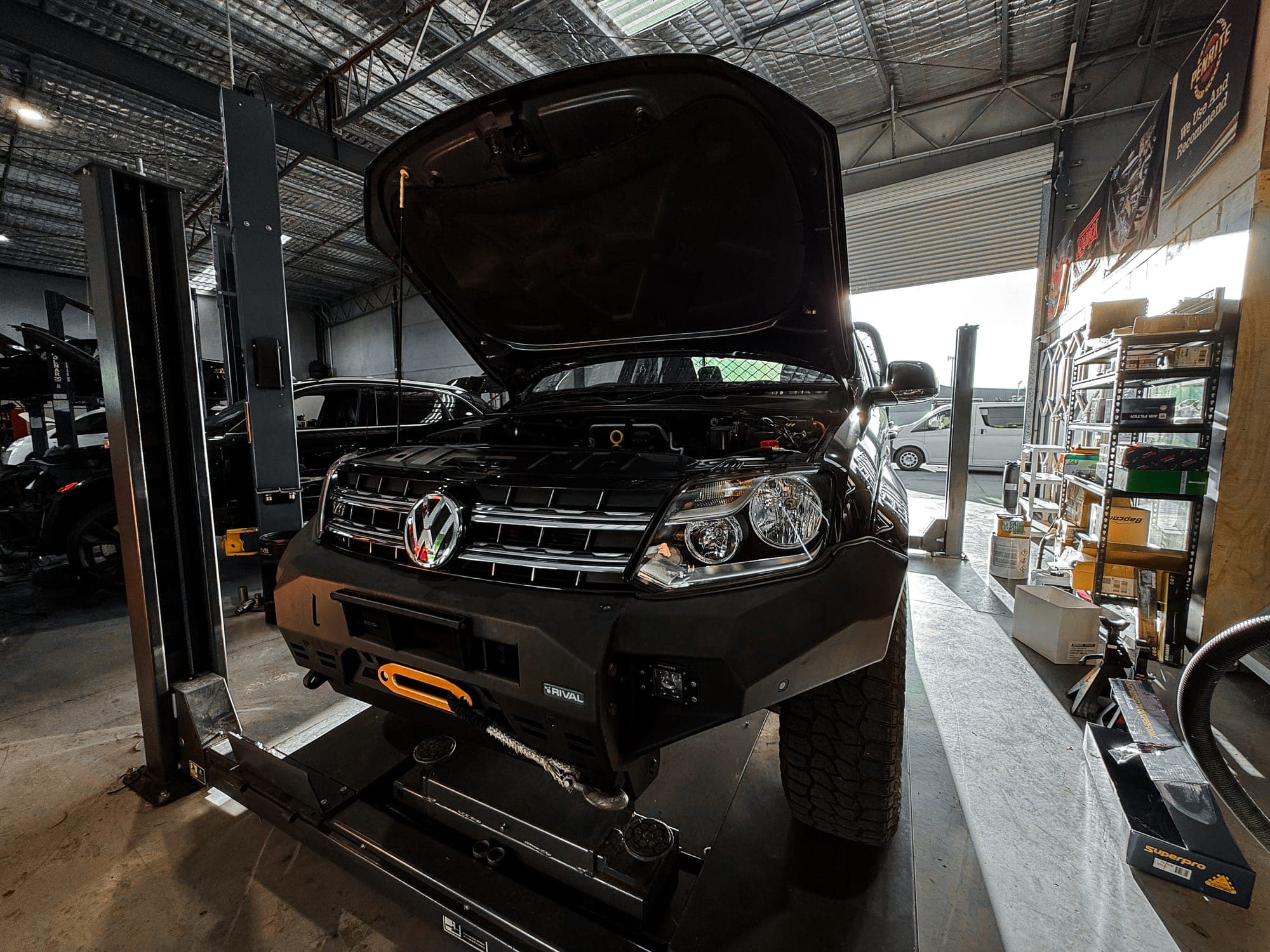 VW Amarok V6 with bonnet up on the hoist for log book service
